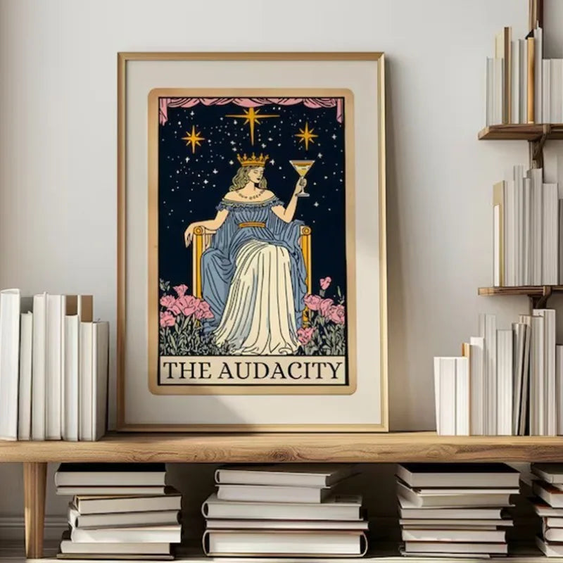 A framed poster featuring a woman crowned with gold, surrounded by stars and pink flowers, titled The Audacity.