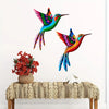 Vibrant metal hummingbird wall art featuring iridescent green, blue, and orange feathers.