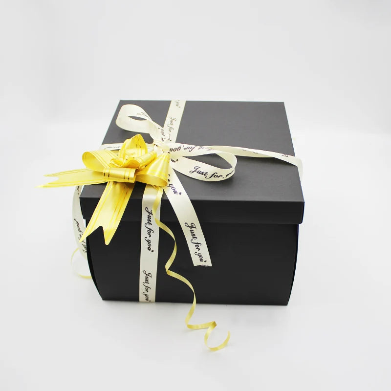 A black gift box tied with a yellow ribbon and a gold bow, labeled Just for you.
