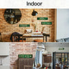 A close-up of a brick wall decorated with vintage retro metal street signs for wall decor.
