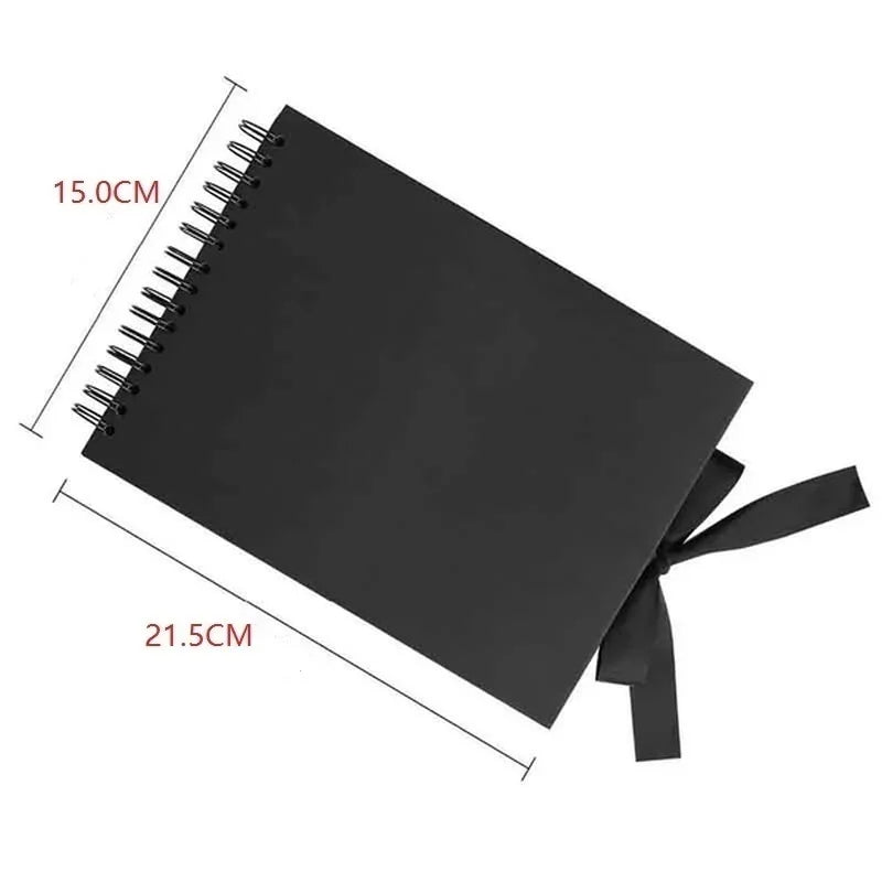 A black spiral-bound photo album with dimensions 15.0cm by 21.5cm.