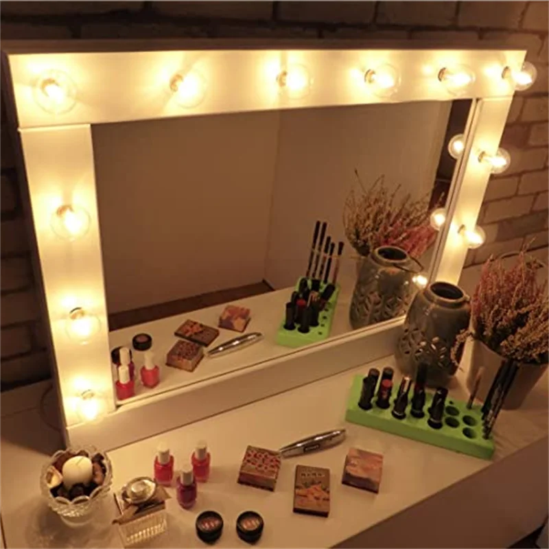 A display of various wax warmer replacement bulbs and candles arranged on a white surface.