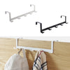 A black iron door and wall organizer rack with five hooks mounted on a light wood surface.