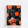 A framed canvas art print featuring overlapping vinyl records in black and orange tones.