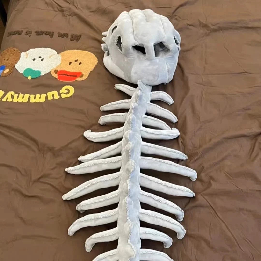 A white wearable dinosaur skeleton costume pillow showing the head and spine structure.