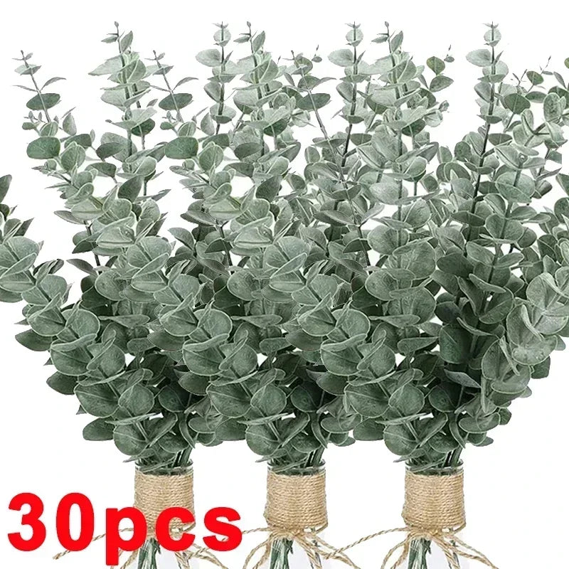 A bundle of artificial eucalyptus stems with realistic green leaves used for home decor and wedding centerpieces.
