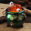 A green glass jar filled with orange liquid holds a Halloween silicone mold set featuring pumpkin and ghost shapes.