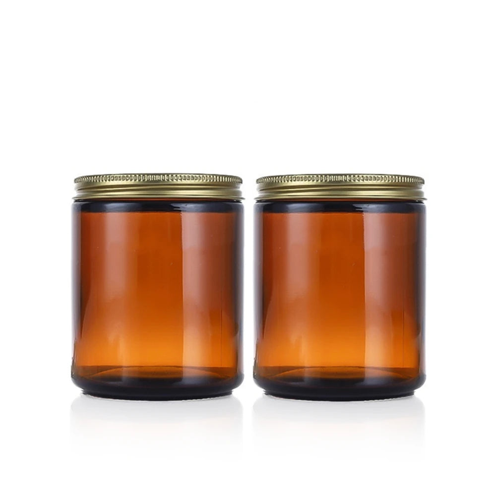 A set of two amber glass jars with airtight lids and labels sitting on a white background.