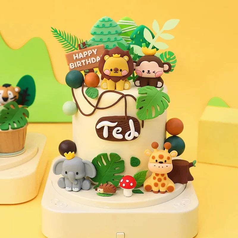 A tiered cake decorated with jungle animal toppers including a lion, monkey, elephant, and giraffe on a yellow background.