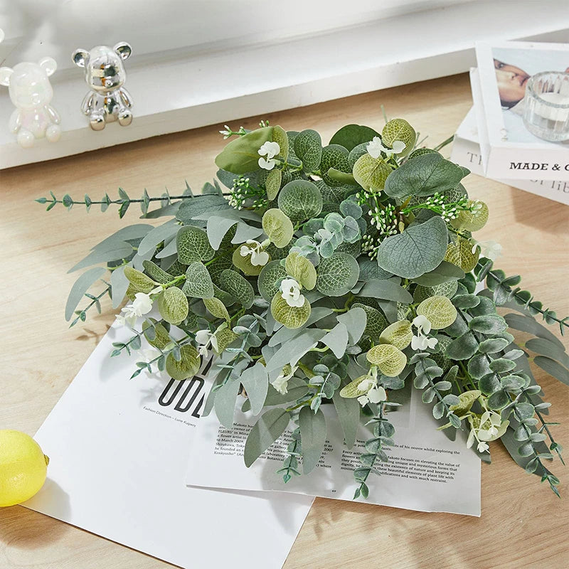 A lush arrangement of mixed artificial eucalyptus leaves in various shades of green and white for DIY decor.