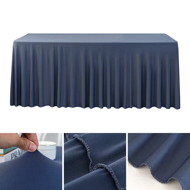 A dark blue stretch rectangle tablecloth draped over a table, showing the fabric texture and pleats.