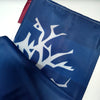 A dark blue fabric banner featuring a white stylized tree or mound design.