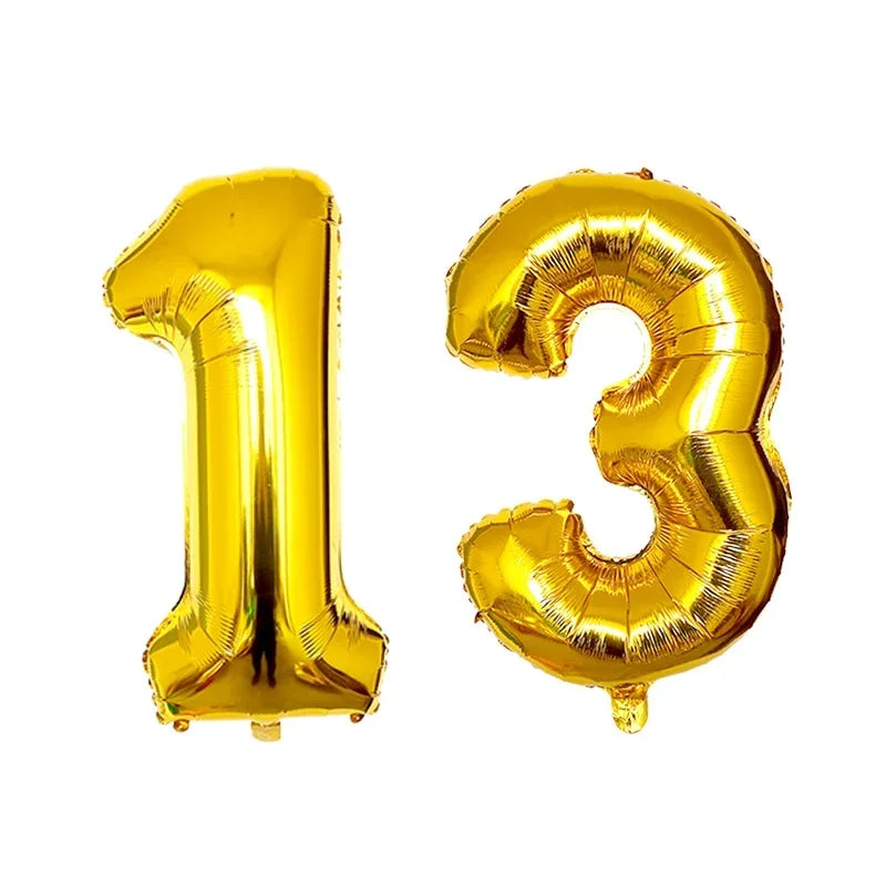 Two gold foil number balloons shaped like 1 and 3 for a birthday party
