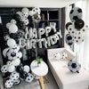A display of silver and black latex football shaped balloons arranged in a festive party backdrop.