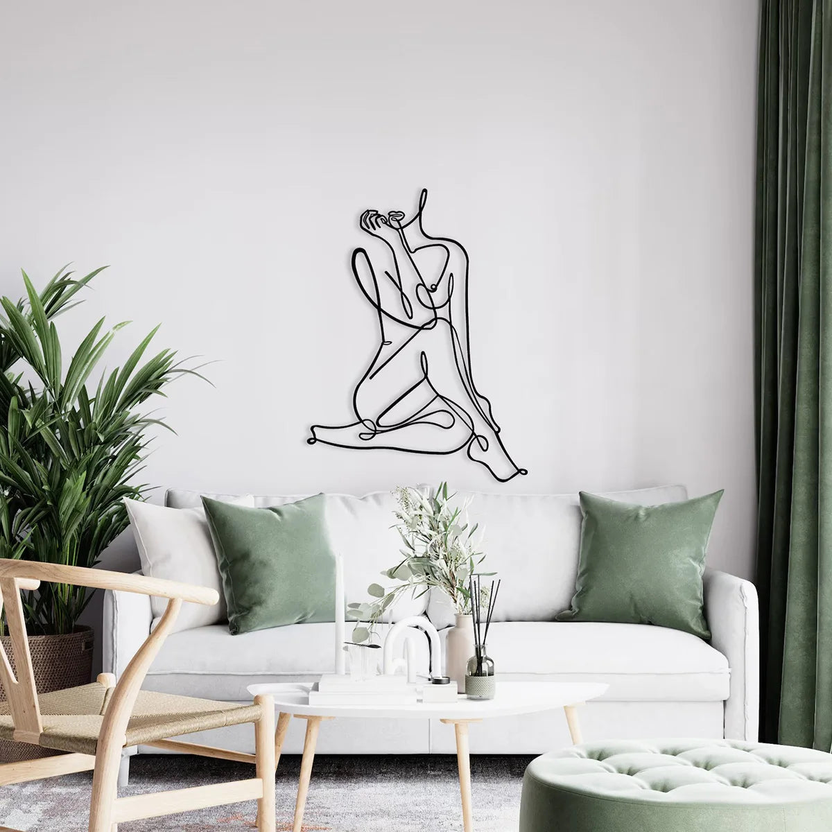 Elegant metal line art wall decor featuring a figure in a reclining pose on a white sofa.