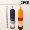 Two multicolor fabric hats hanging on a wooden rack for closet storage
