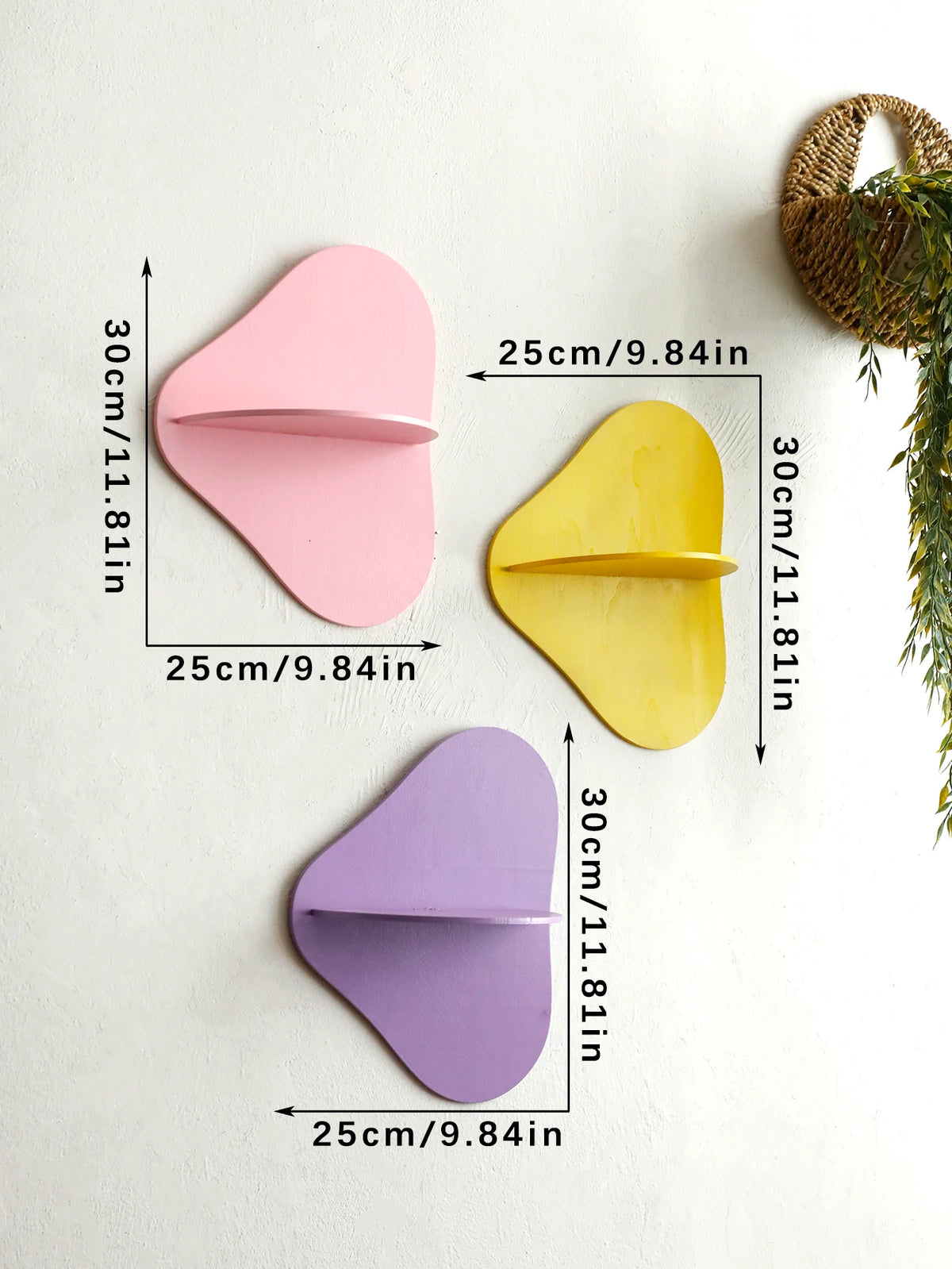 Three cherry-shaped wooden wall shelves in pink, yellow, and purple displayed against a white background.