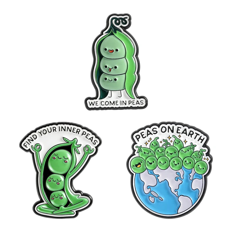 A set of enamel pins featuring cartoon characters and nature designs, including a pea character and a globe with peas on eart