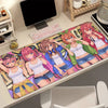 A desk mat featuring five female anime characters from The Quintessential Quintuplets series with a colorful background.