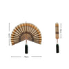 Handwoven bamboo wall fan decor with a pleated design and tassel