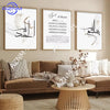 A framed print featuring elegant black Islamic Arabic calligraphy on a white background displayed in a modern living room set