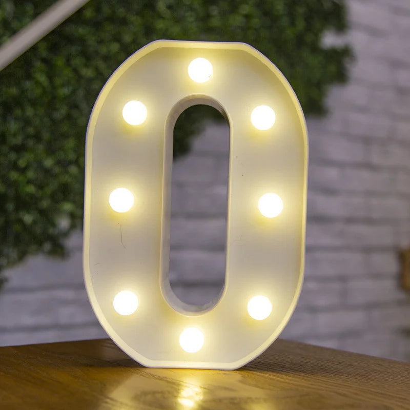 A glowing white alphabet letter light shaped like the number zero, illuminating the surrounding area.