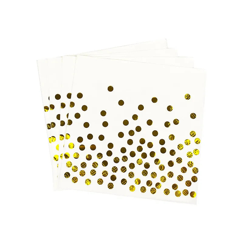 A stack of white and gold disposable party tableware featuring a dot pattern.