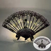 Elegant black lace folding fan with translucent panels and traditional Chinese design