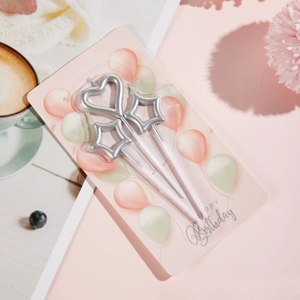 A set of gradient blue metallic birthday candles is displayed on a pink card against a light background.