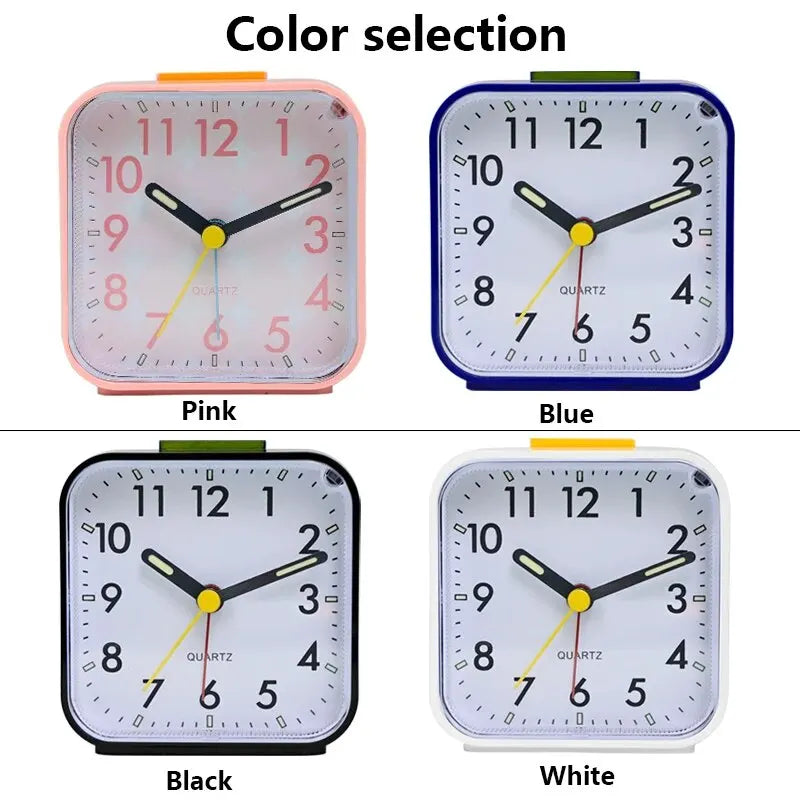 Four variations of a compact alarm clock showing pink, blue, black, and white colors with quartz movement.