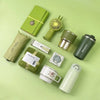 A green gift set featuring a tumbler, towel, and UPF sun protection item on a light green background.