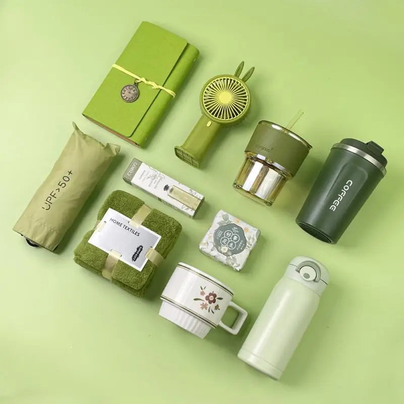 A green gift set featuring a tumbler, towel, and UPF sun protection item on a light green background.