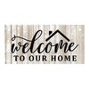 Rustic wooden hanging sign with black script text that reads Welcome to our home