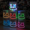 A set of four glowing neon LED party masks featuring various flashing light modes and smiling facial expressions.