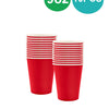 A stack of red paper party tableware including cups, plates, napkins, and cutlery.