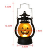 A black hanging lantern shaped like a carved jack-o'-lantern with an illuminated face.