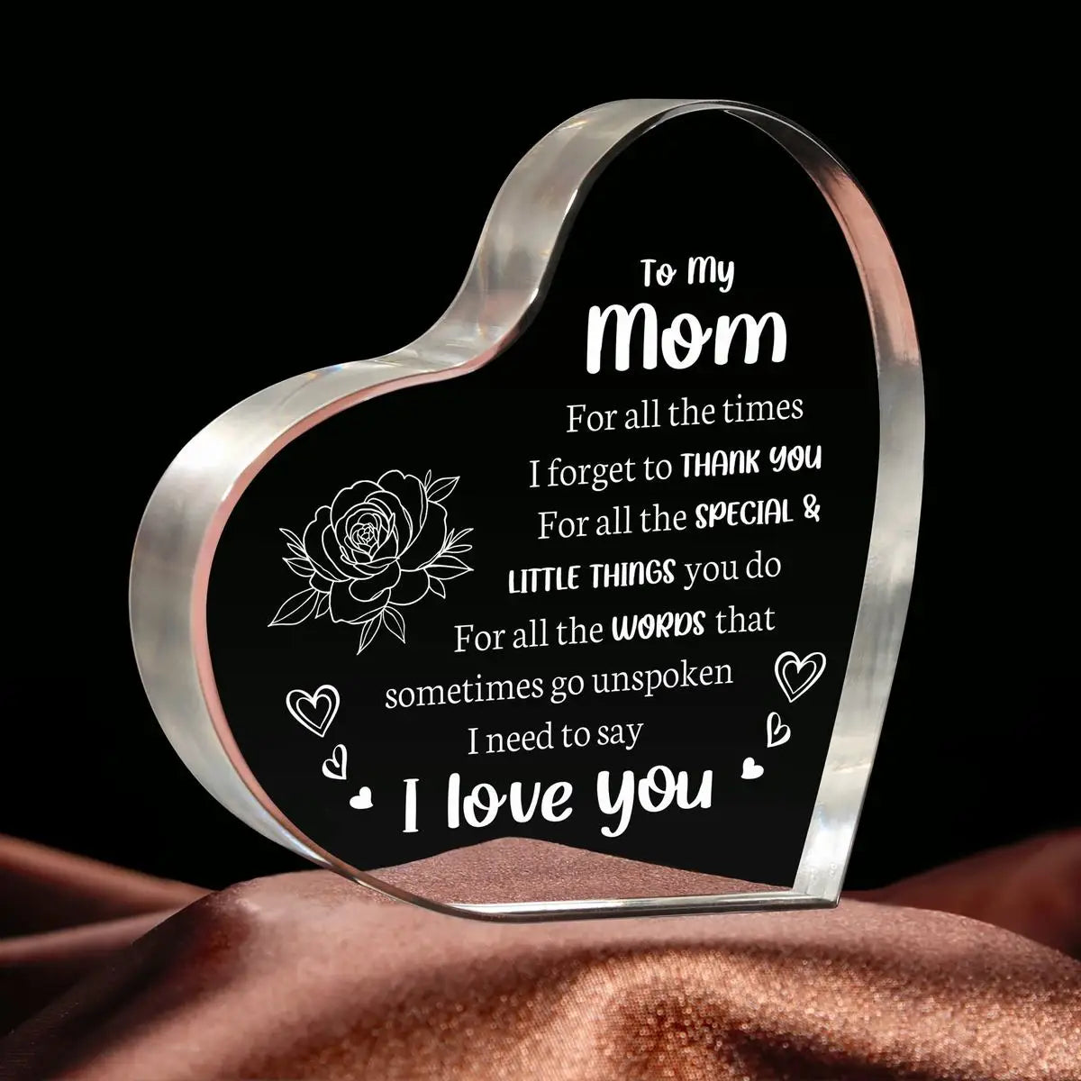 A clear acrylic heart pendant engraved with the message I love you to my mom