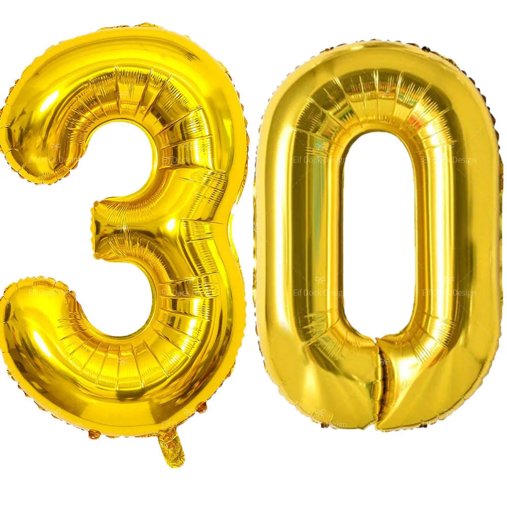 A large, shiny gold foil balloon shaped like the number 30.
