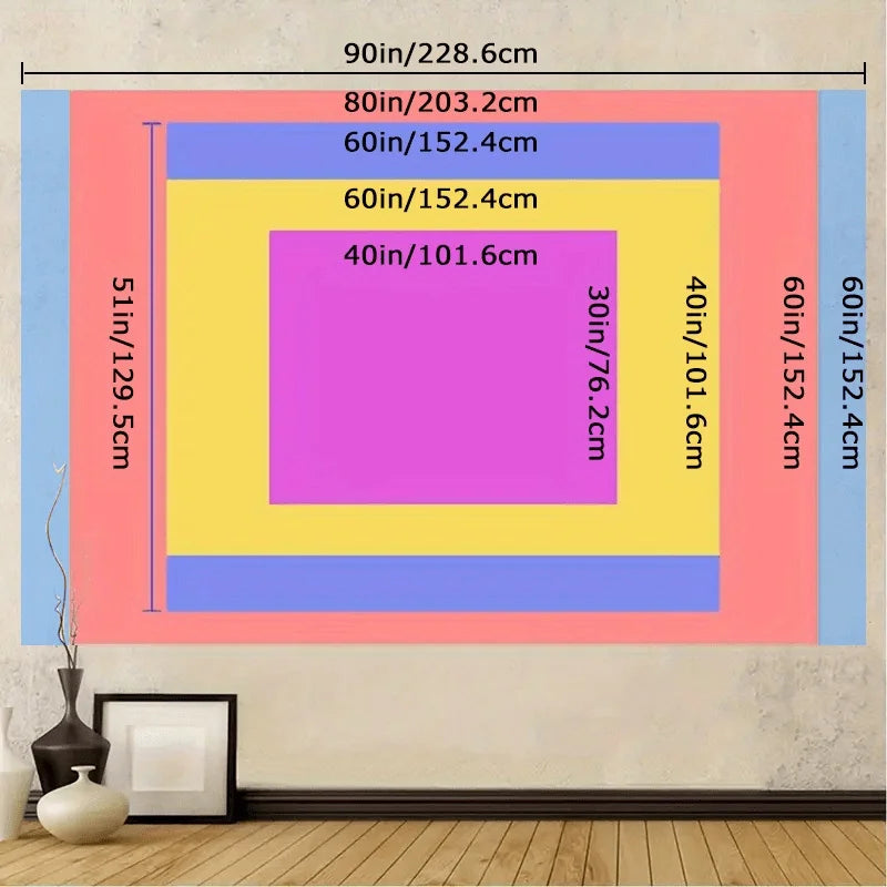 A colorful layered wall hanging design featuring pink, yellow, and blue geometric shapes on a light gray wall.