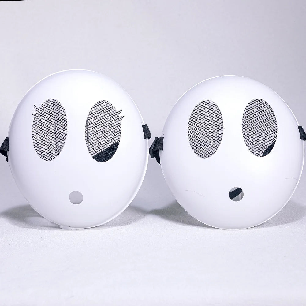 A pair of white Shy Guy cosplay masks with black eyes and a small nose, displayed against a white background.