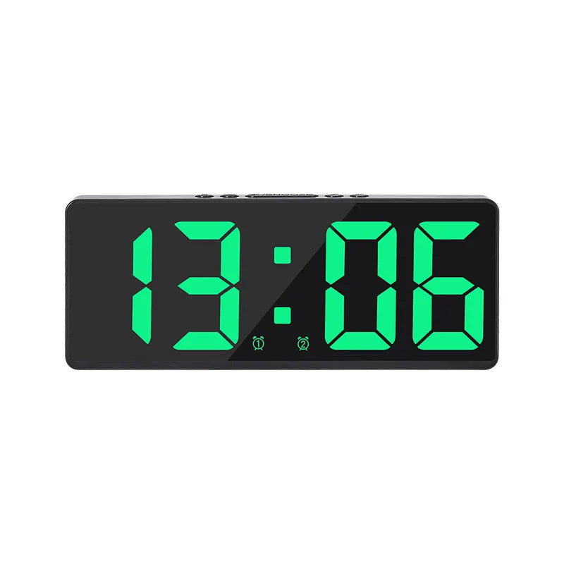 A black digital alarm clock displaying the time 13:06 in bright green LED digits.