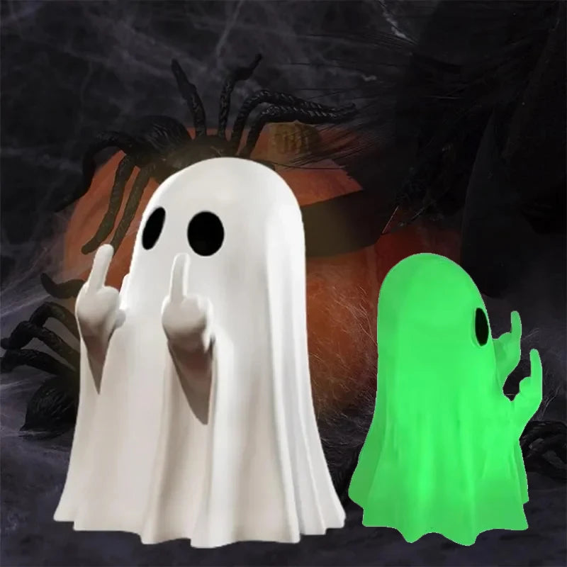 A white ghost figurine with a playful pose next to a bright green glow-in-the-dark ghost figurine against a dark background.