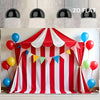 A red and white striped circus party backdrop banner with colorful bunting and balloons.