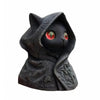 A dark, black gothic hooded cat statue with glowing red eyes.