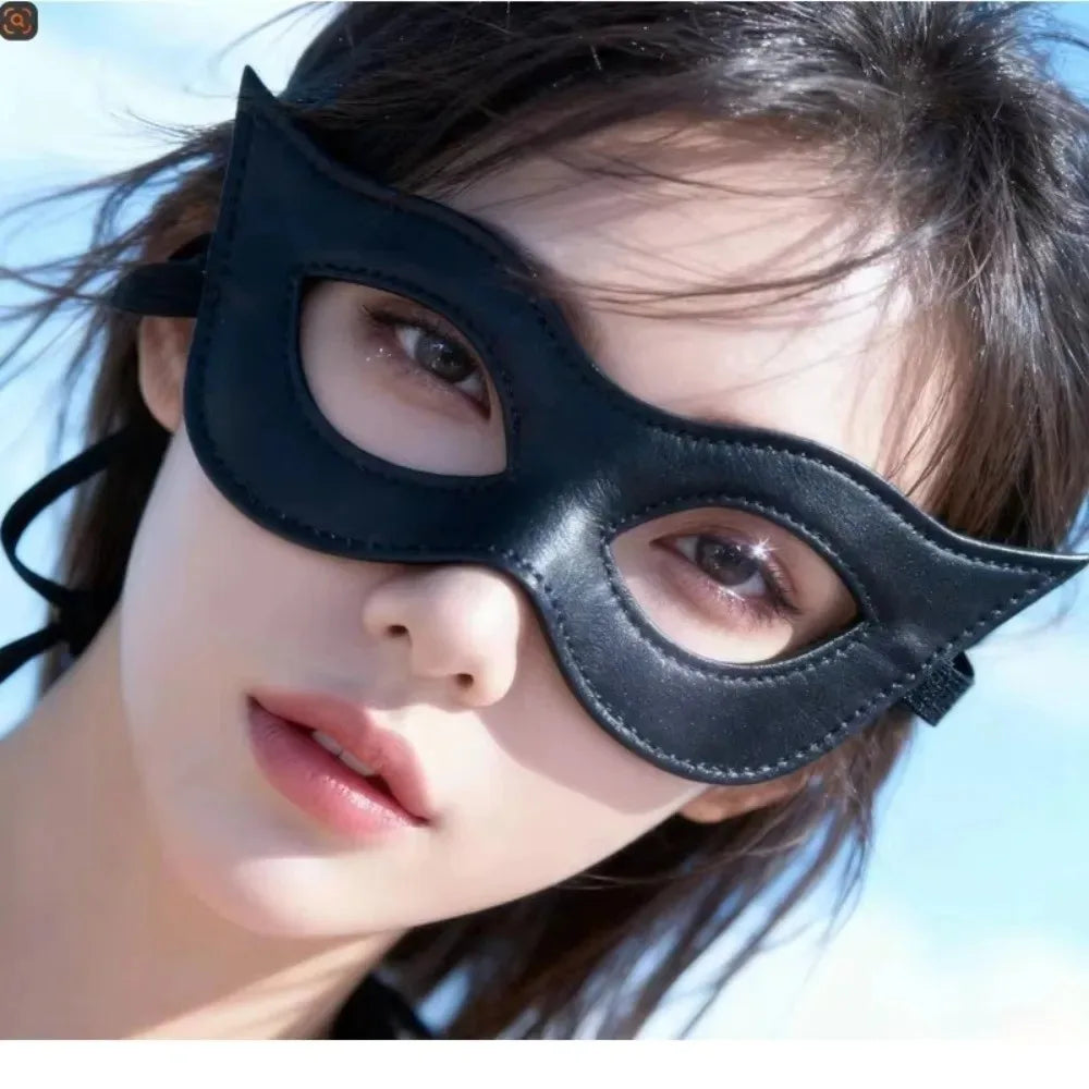 A close-up of a woman wearing a black PU leather cat eye masquerade mask.