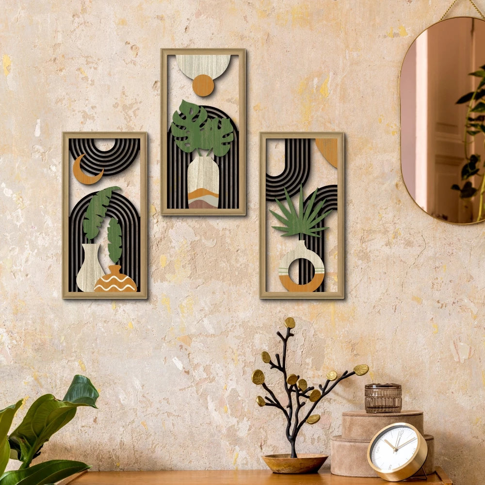 A set of three framed boho wood leaf wall art pieces featuring natural tones and geometric shapes on a textured wall.