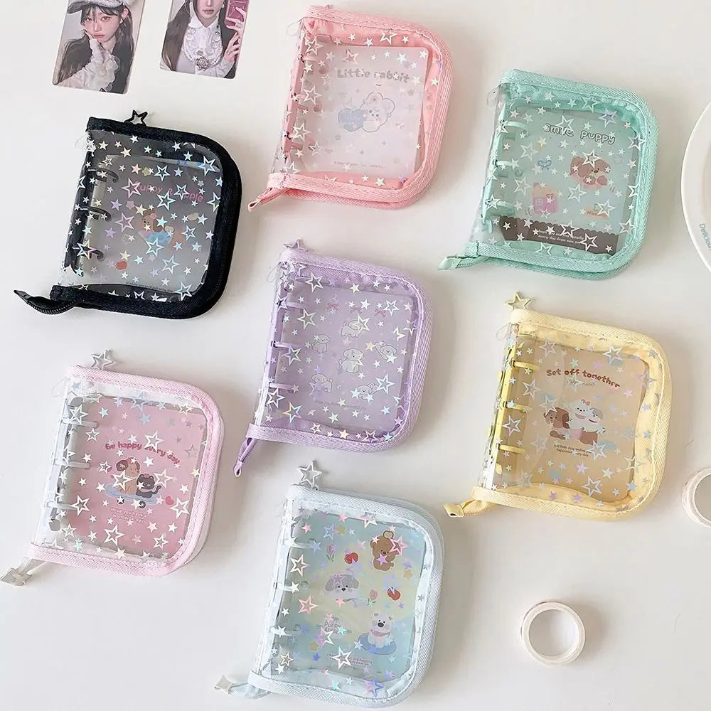 A collection of five glitter star card binders in various pastel colors including pink, green, purple, yellow, and blue.
