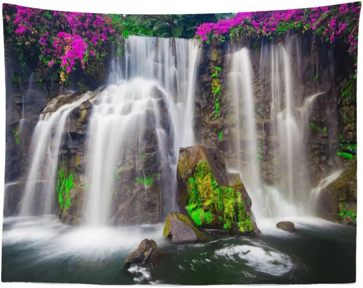 A panoramic photograph of a waterfall cascading down mossy rocks surrounded by lush green rainforest foliage.