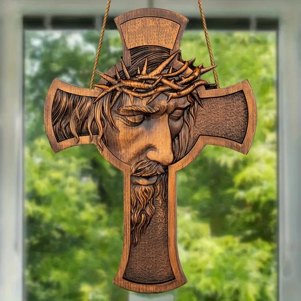 A wooden cross wall decor featuring a carved depiction of Jesus with a crown of thorns.