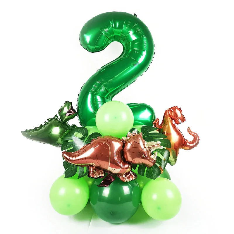A green foil number 2 balloon surrounded by green and gold dinosaur-themed balloons.
